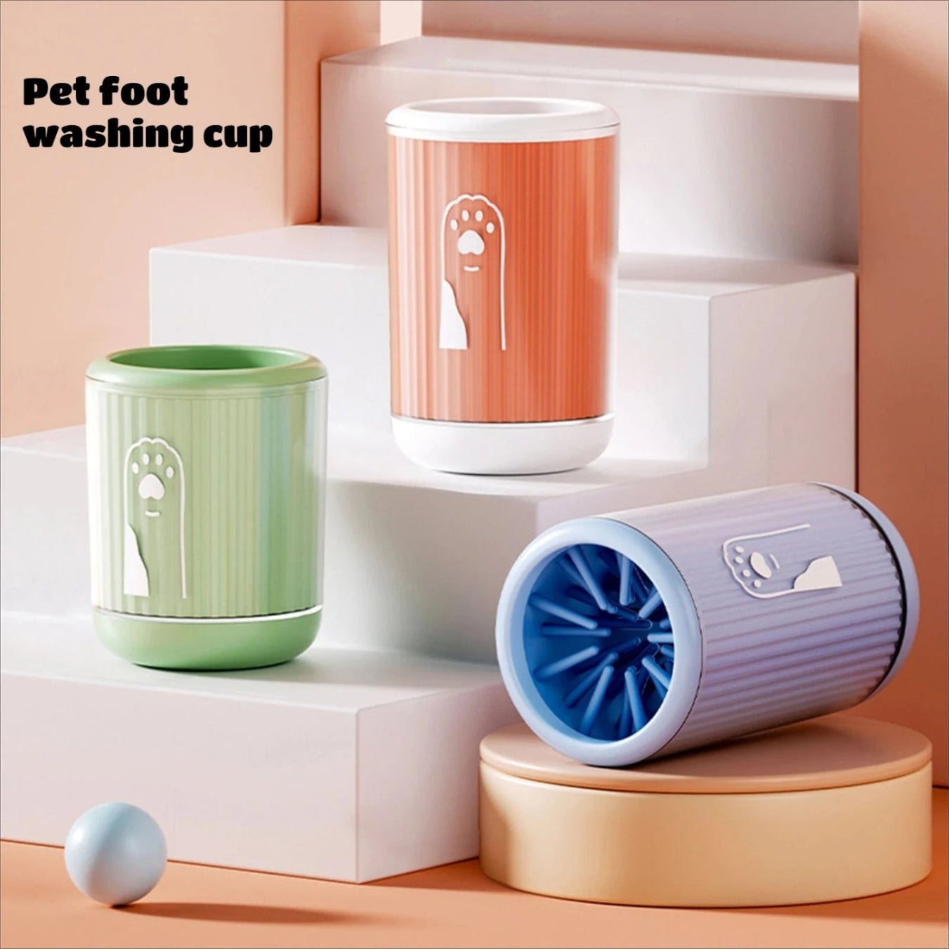 Three pet foot washing cups in different colors on a white platform with a peach background.